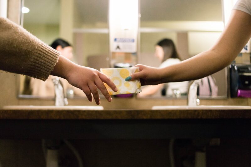 People passing a note to one another