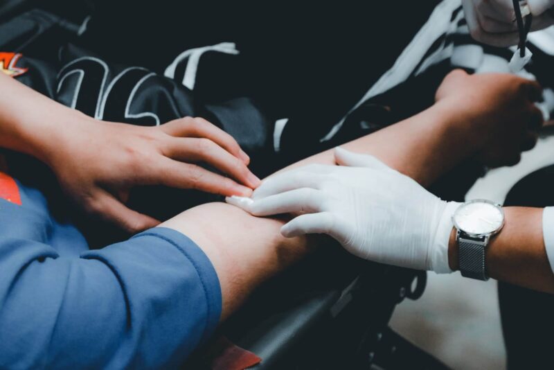 A healthcare professional taking blood from a person